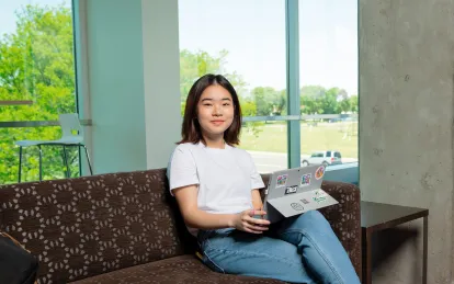 student on a laptop sitting on a couch