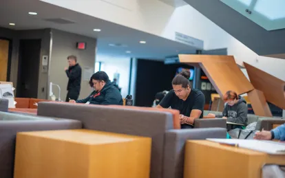 students working on a project in a lounge area