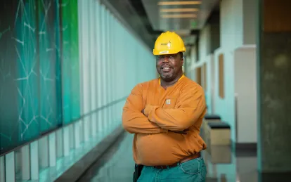 man wearing a construction hat standing in a hallway 