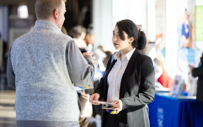 student speaking with an employer at a job fair 