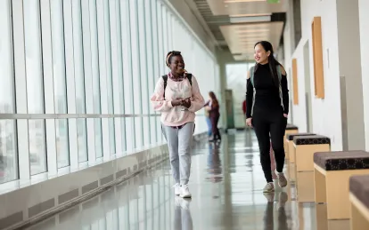 Two students walking and talking