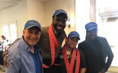 alumni smiling in a golf clubhouse