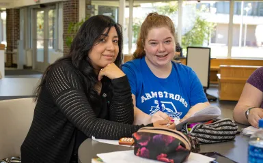 a student smiling next to their mentor