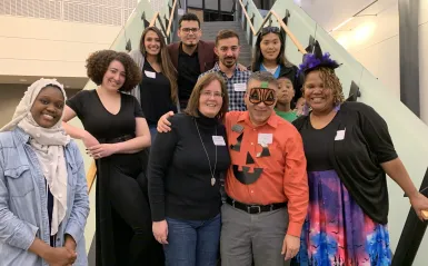 group of alumni and staff on a staircase