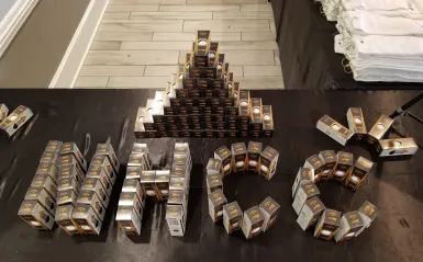 packages of branded golf balls organized on a table to spell NHCC