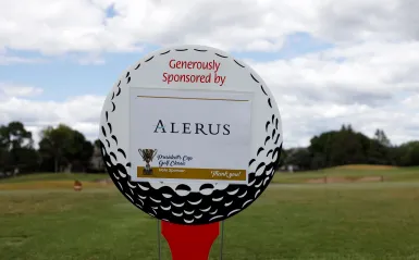 picture of a sign shaped like a golf ball reading the name f the sponsor