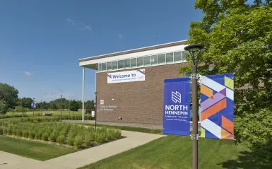 colorful banner with nhcc logo and a banner on a building with the word welcome