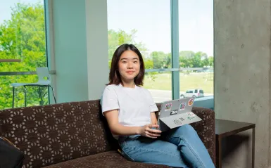 student on a laptop sitting on a couch