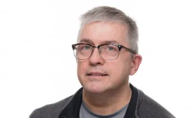 man smiling with glasses