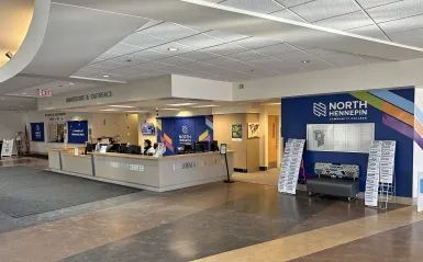 front desk area with signage and a person at the desk