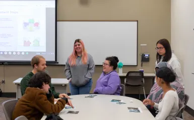 students talking around a table in a classroom 