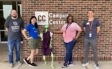 group of people in front of "Campus Center" sign