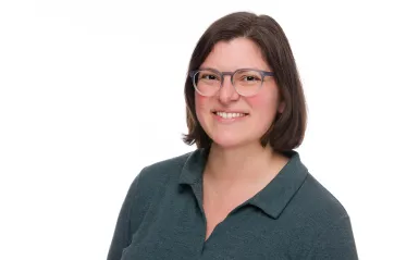 woman smiling wearing glasses with a white background