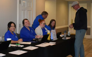 Volunteers checking in guests at Registration Table