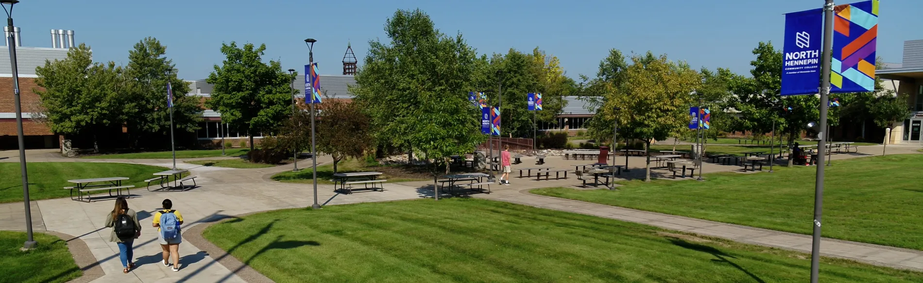 Students walking on campus on a sunny day