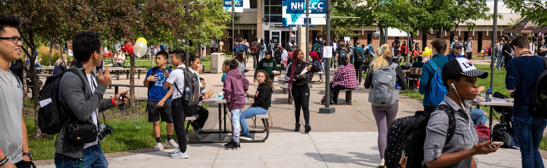 Students on campus walking around during a picnic on a sunny day