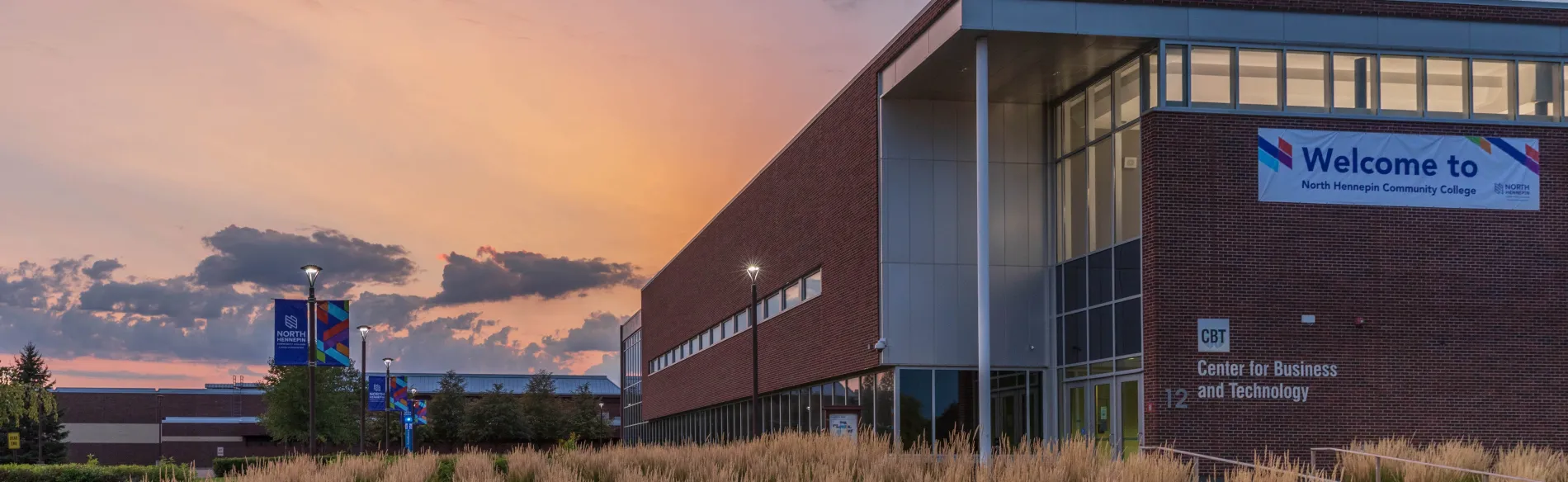 Large business and technology building in the evening with the sun setting in the background. 