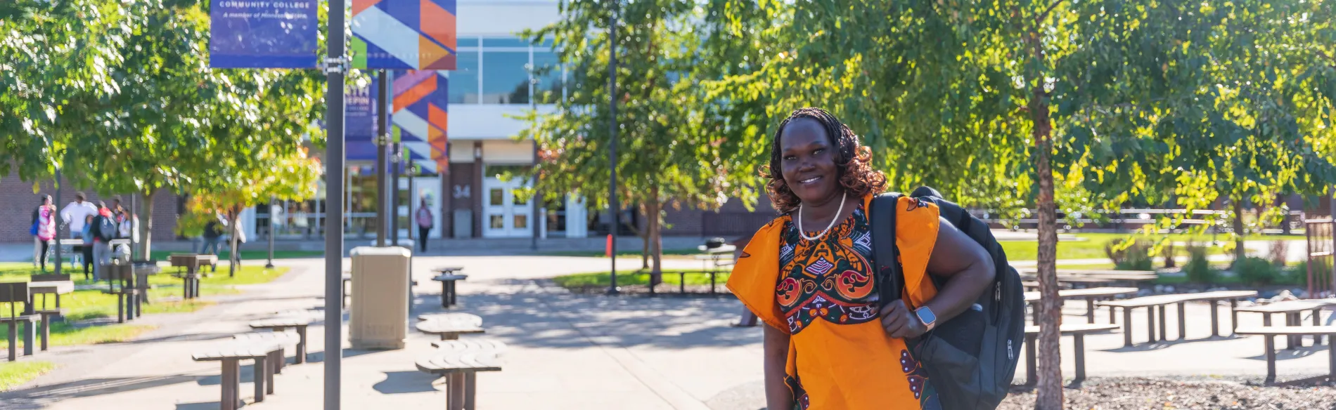 student outside smiling on a sunny day