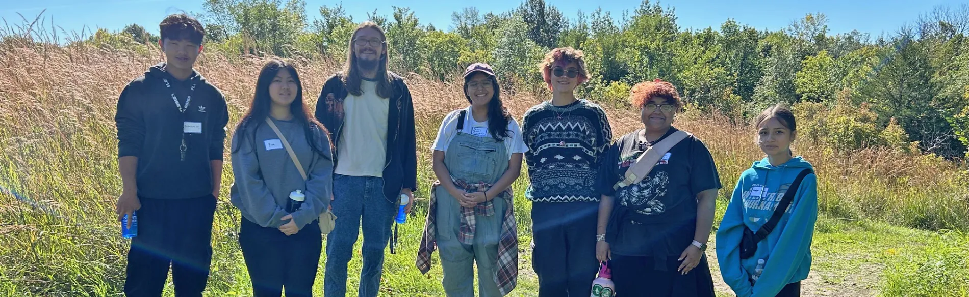 students standing in a field on a sunny day