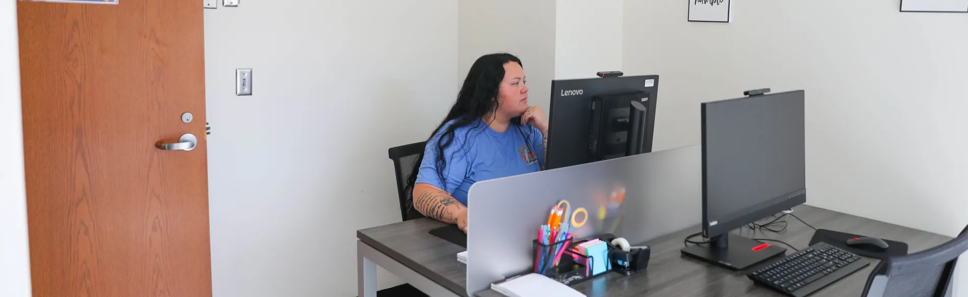 student sitting at a desk with a computer 