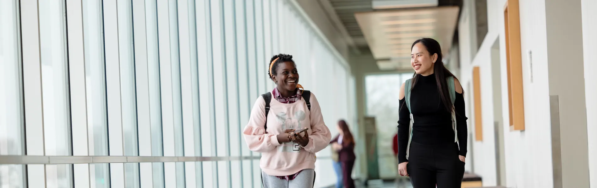 students walking in a hallway smiling