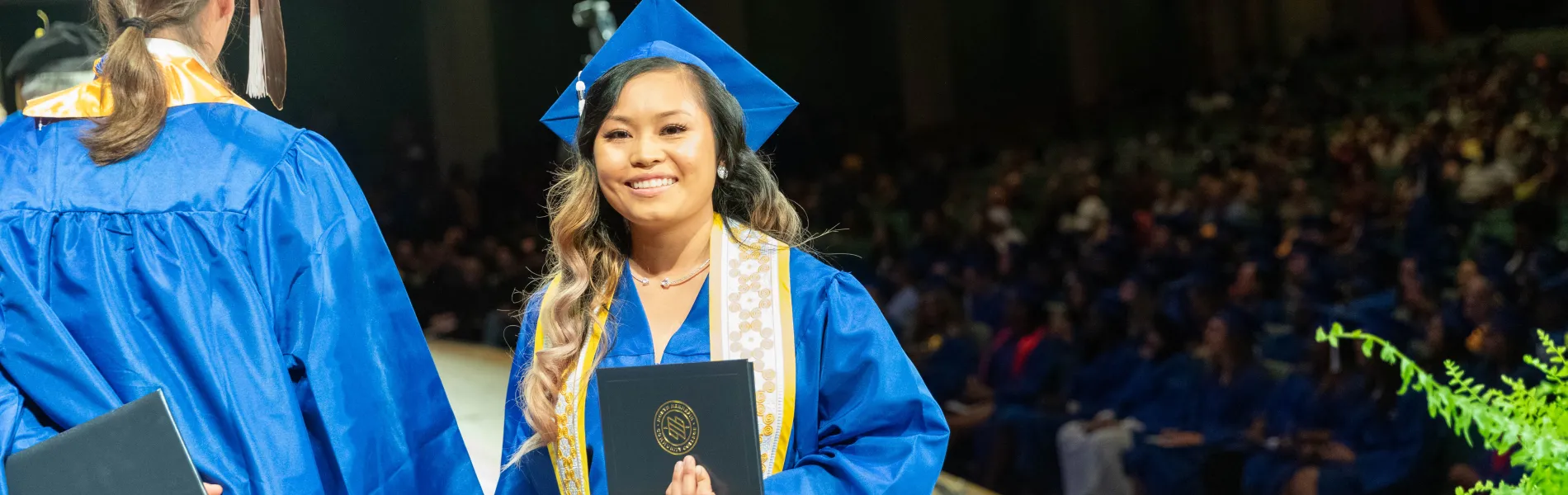 graduate at commencement in cap and gown 