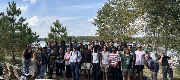 big group of students outside near trees