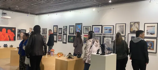 students walking around in an art gallery