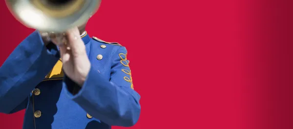 person playing a trumpet with red background 