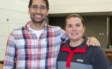 male and female faculty members smiling inside