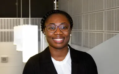 paralegal student Sehlone standing inside smiling at camera