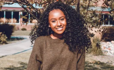 female student smiling outside