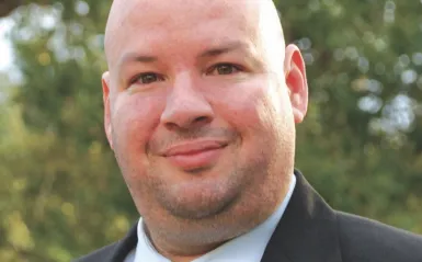 NHCC president Rolando Garcia standing outside smiling at the camera