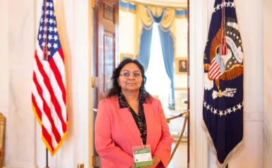 Dr. Eugenia Paulus standing inside white house