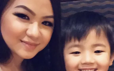 STEM Student Mee La Khang posing for a selfie with her son