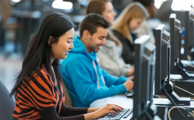 photo of students near a computer