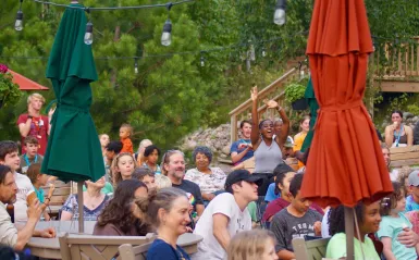 Photo of adults and young adults outside at summer camp