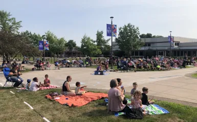 a photo of people in NHCC's courtyard during the summer