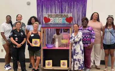 NHCC's Sista Hope 2 group with a local girl's lemonade business 