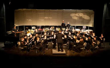 a concert band performing on stage 