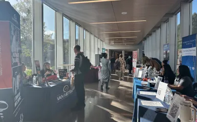 hallway during a career fair with tables and students wandering