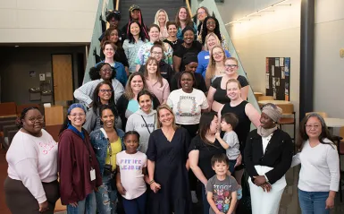 groups of smiling students and mentors on staircase