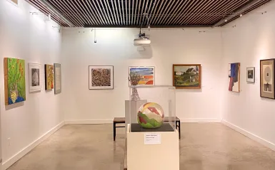 a photo of various styles of artwork on display in the gallery. 