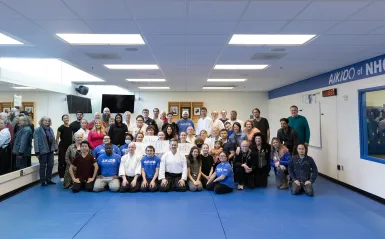 group of students and instructors in the aikido dojo 
