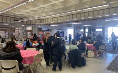 a photo of students gathering, sitting at tables and conversing at our Student Appreciation Day event in the Campus Center. 