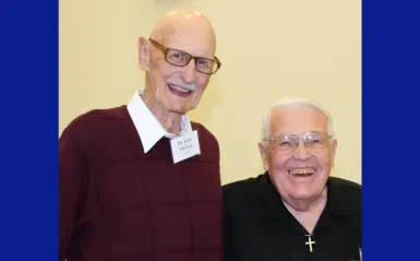 this is a photo of two legendary men in NHCC's history. Smiling next to each other are, former and longest serving NHCC President, Dr. John Helling on the left, next to Eldon Tessman, devoted community member and NHCC Foundation establisher in 2019 at an on-campus event. This is one of the final photos taken of them together.