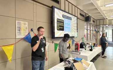this is a photo of NHCC Student Life staff, calling bingo cards at an event in the Campus Center. 