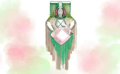 this is a photo of a handwoven green and pink macrame hanging art piece, created by artist, Liz Miller. 