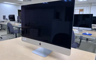 this is a photo of an iMac computer sitting on a desktop in a classroom on-campus. 