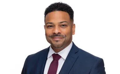 this is a professional headshot photo of Vice President of Student Affairs and Enrollment Management, Julio Vargas-Essex. 